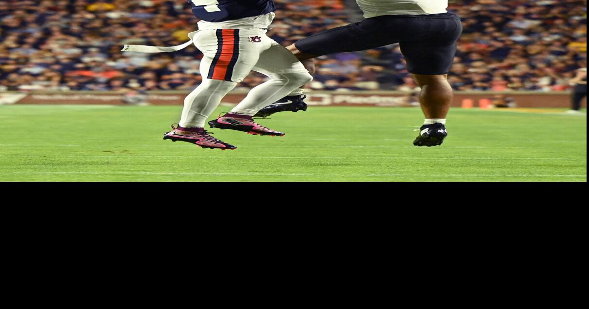 Auburn cornerback Kayin Lee (4), left, intercepts