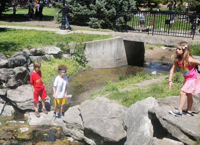 Children play in the Peace Park creek