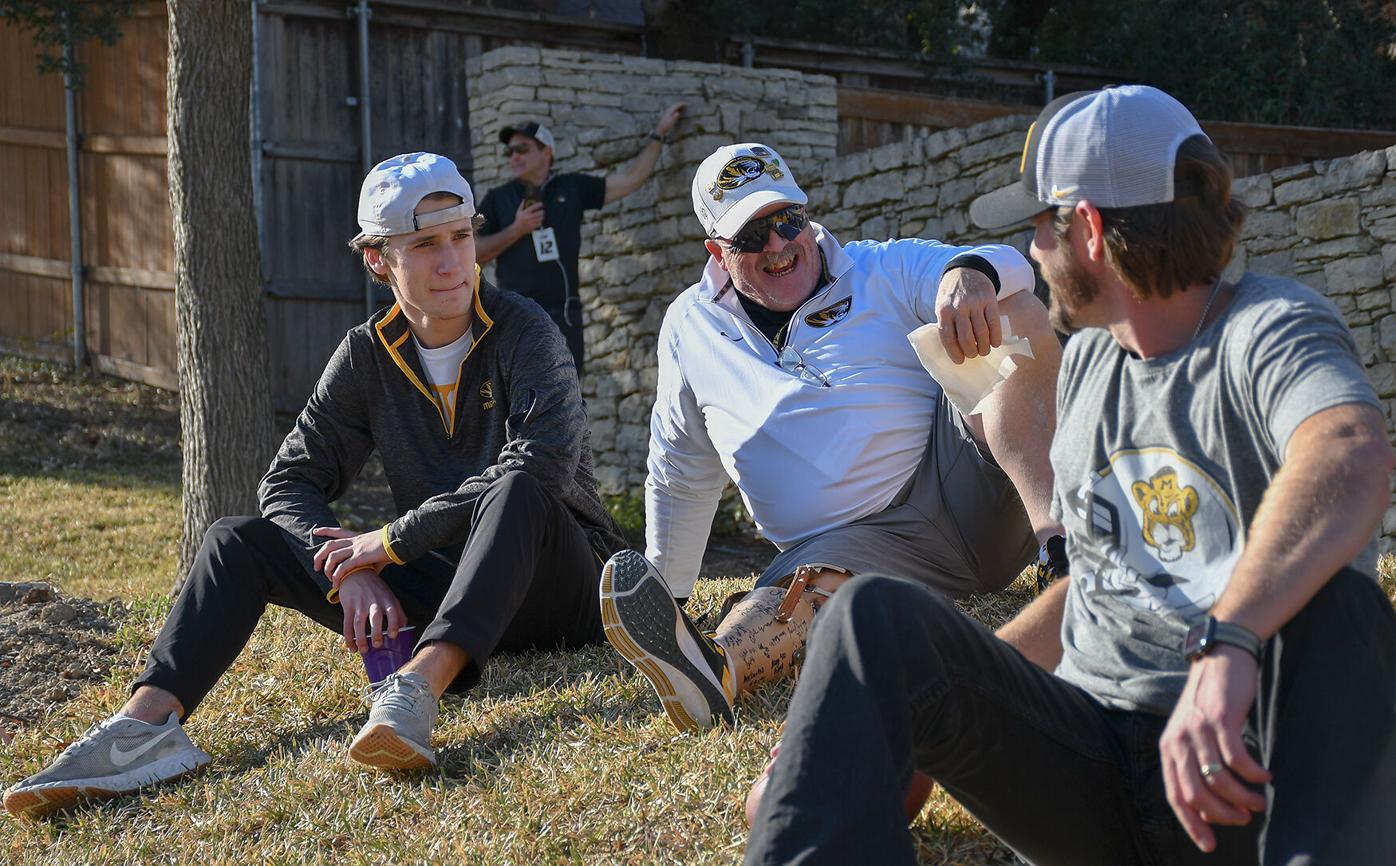 From left, Nick Politte, Brian Garner, and Matt Martin chat on the front lawn
