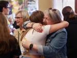 Melissa Hagemann, left hugs Connie Rushing
