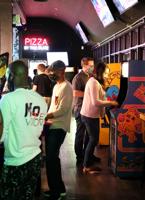 Visit Up-Down Arcade Bar for nostalgic games, homemade pizza, and craft beer