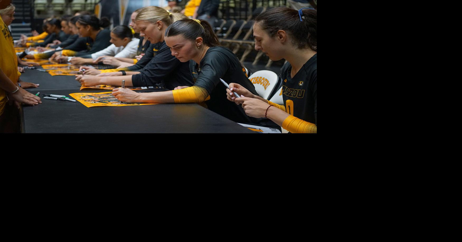 Grace O’Reilly (40) signs a poster during the team’s post-match
