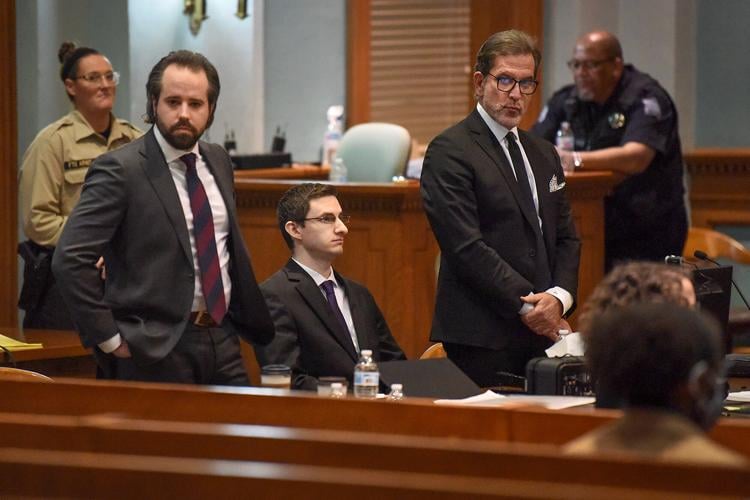 Joseph Elledge, center, sits while his lawyers look in the direction of his mother