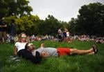 Jamie Arndt rests his head on Stephanie Reid-Arndt while they watch the eclipse