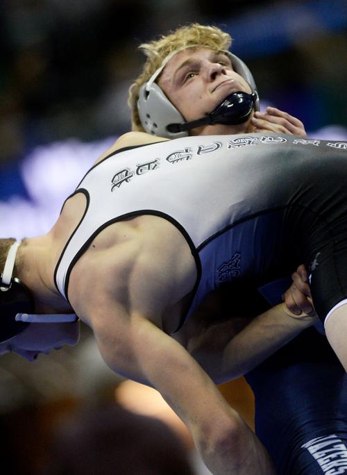 Fr. Tolton Catholic's Teague Travis attempts to throw Conner Johnston of Knob Noster