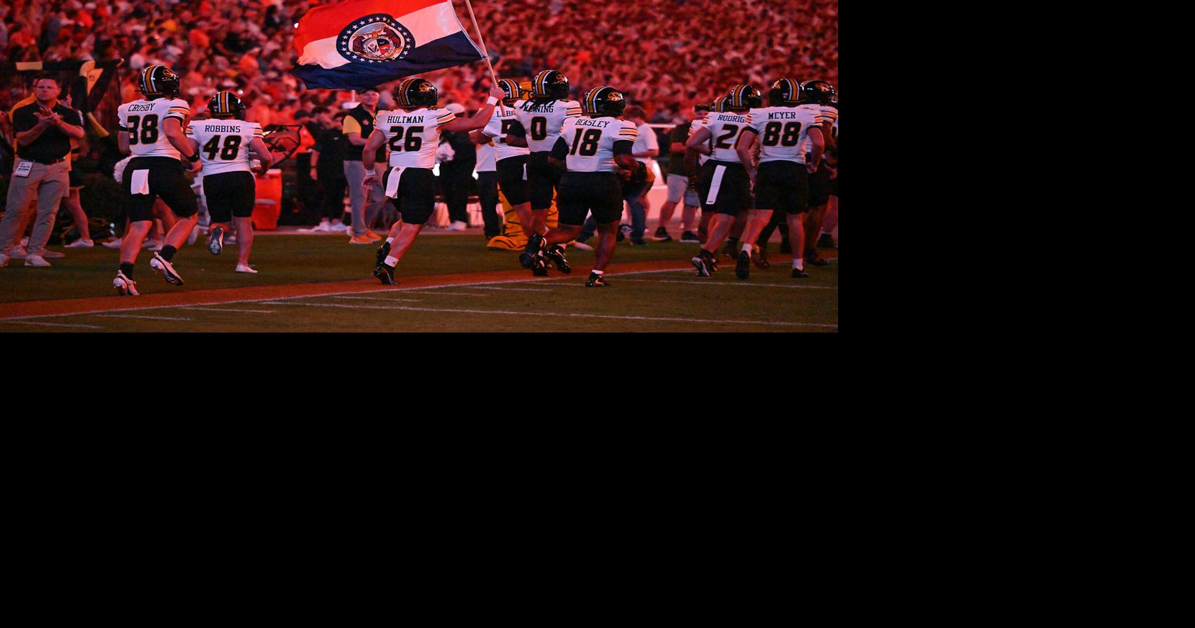 Missouri cornerback Shamar McNeil (26) holds the Missouri state flag