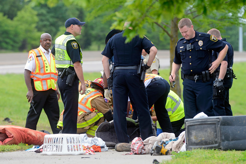 Officials surround an injured man