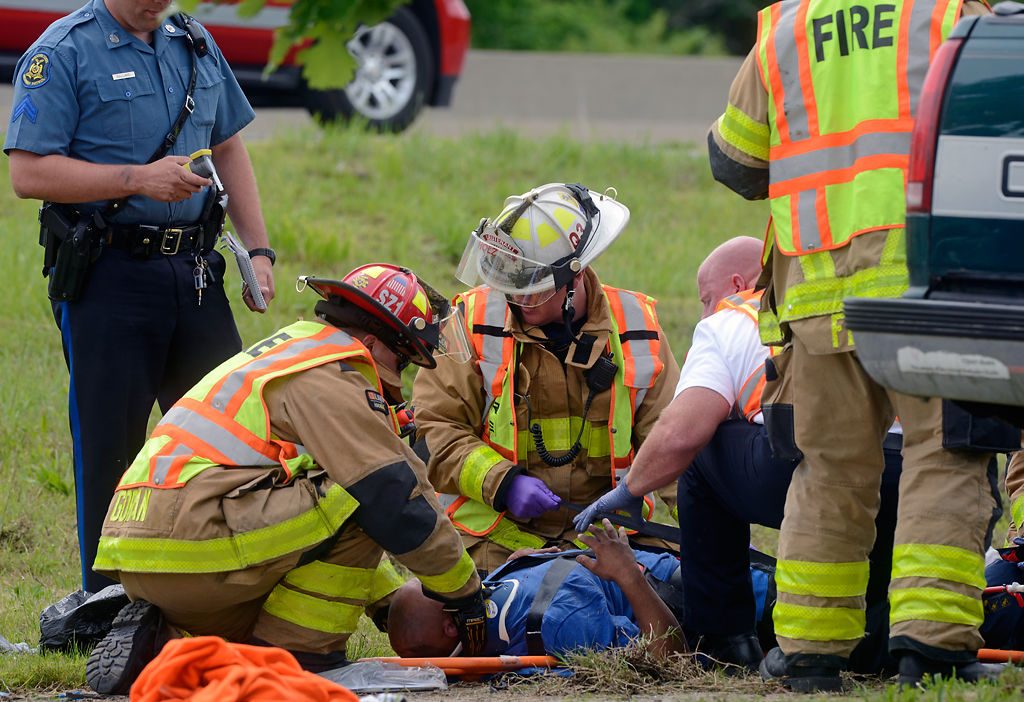 Scott Ballard attends to an injured man