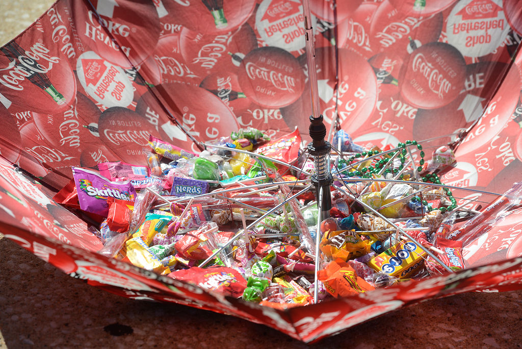 An umbrella filled with candy sits on the sidewalk of Ash Street