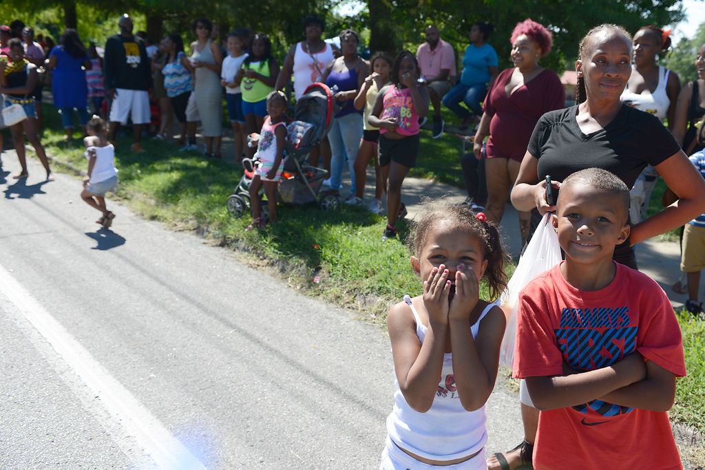 Tarrie Brown, 4, center left, covers her mouth