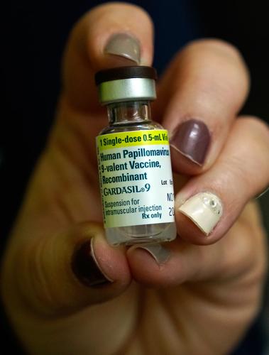 Public health nurse holds a vile of HPV vaccine