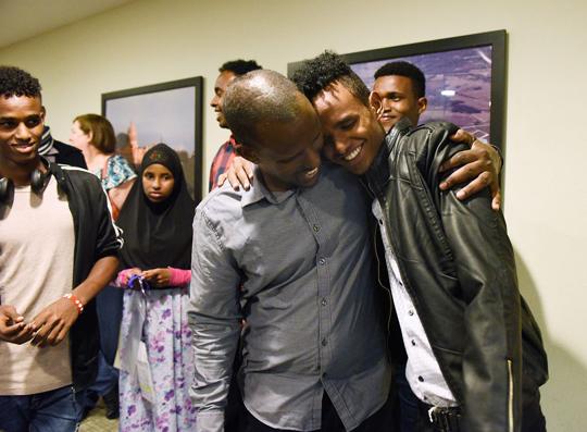 Abshir Abdirahman hugs his son