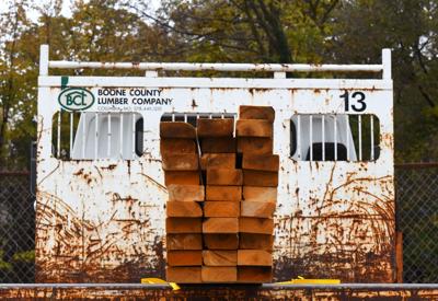 A stack of lumber rests on the back of a returns truck