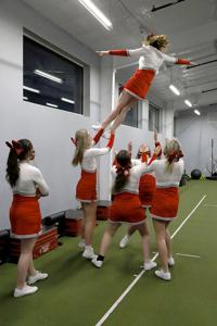 Harrisburg High School cheerleaders catch Sadie Brister