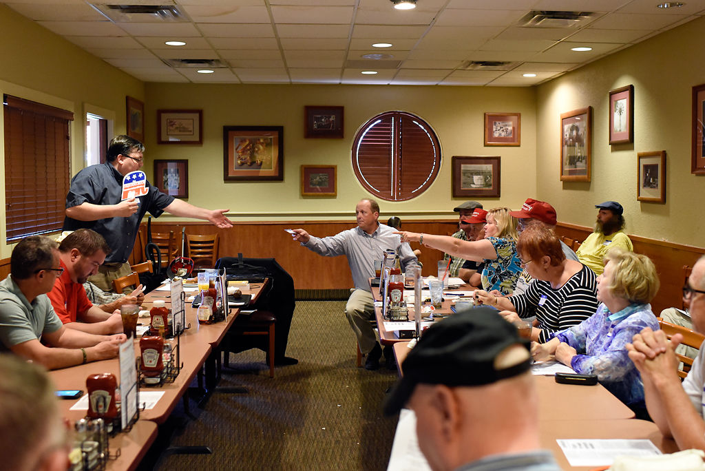 Bryan Chapman Hands A Name Tag To Mike Zweifel Photos