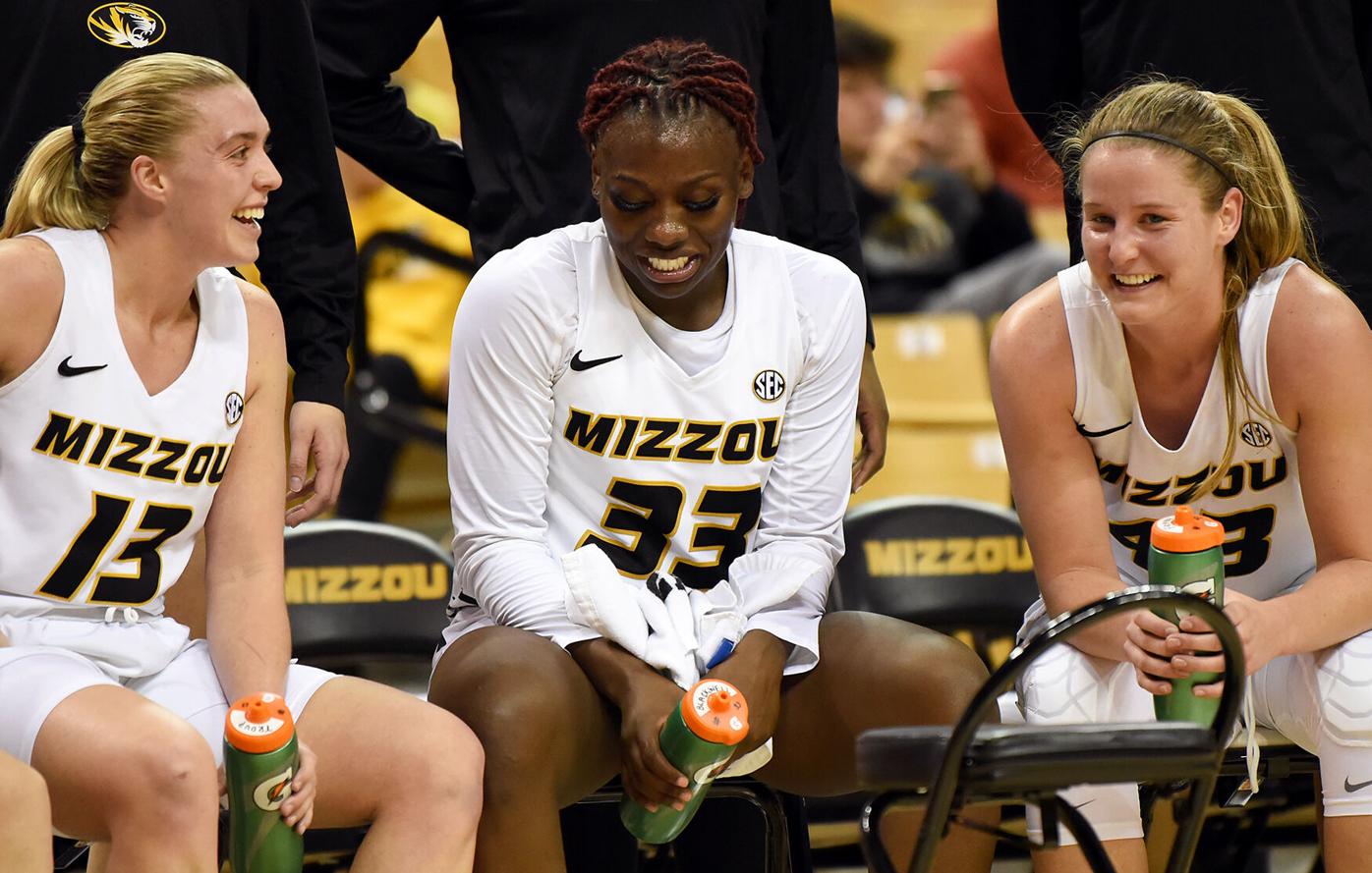 Haley Troup, Aijha Blackwell and Hayley Frank laugh on the bench