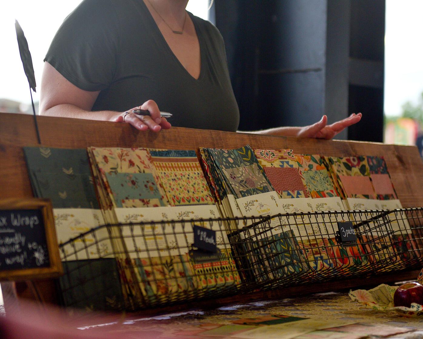Hailey Phelen shows her handmade beeswax wraps