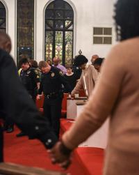 People hold hands for one final prayer