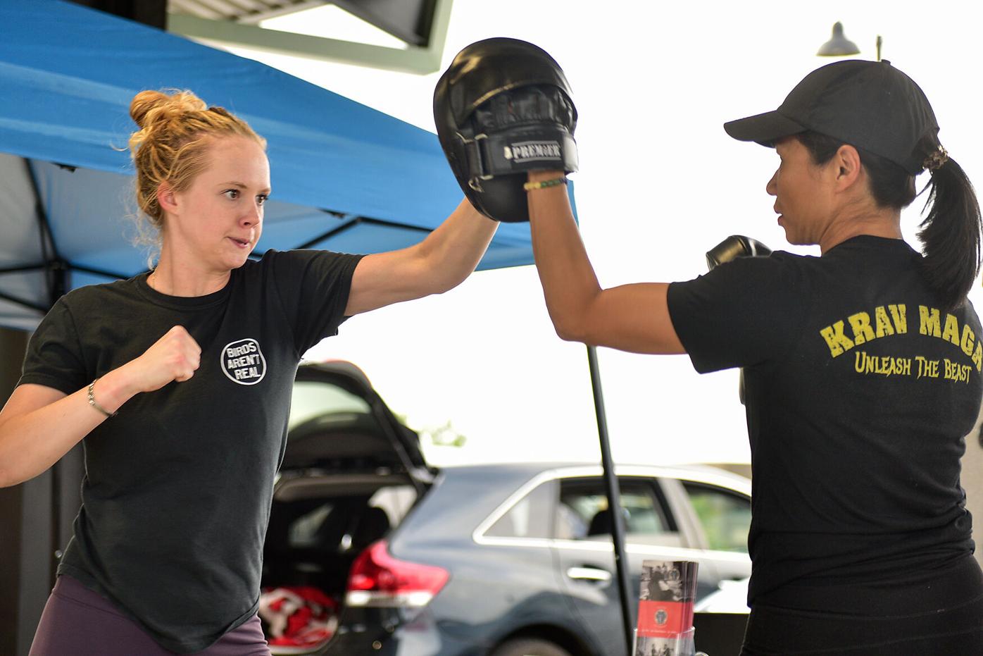 Nicole Meister, left, and Gina Khine demonstrate a fight