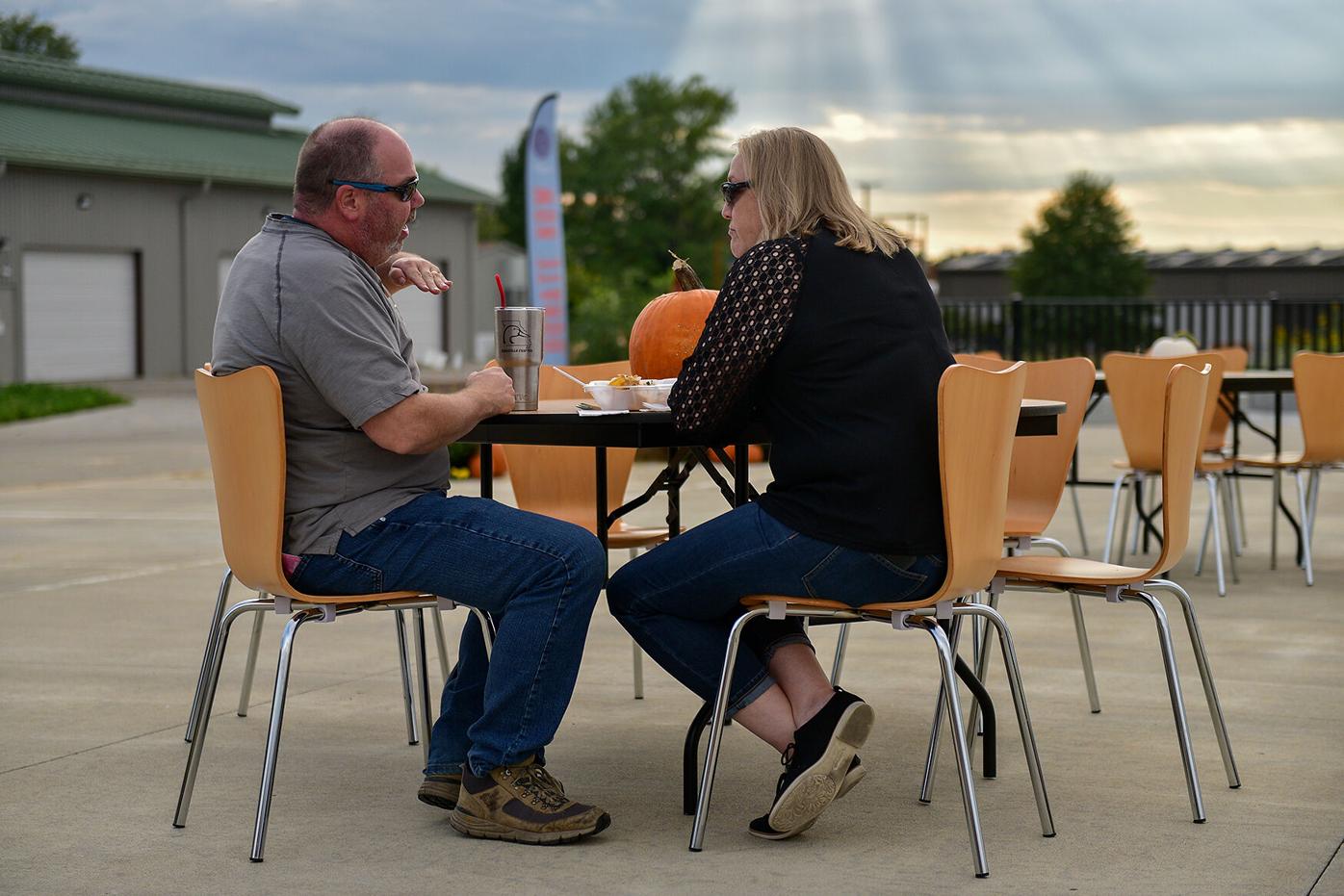 Jason Goran, left, and Lisa Goran eat together