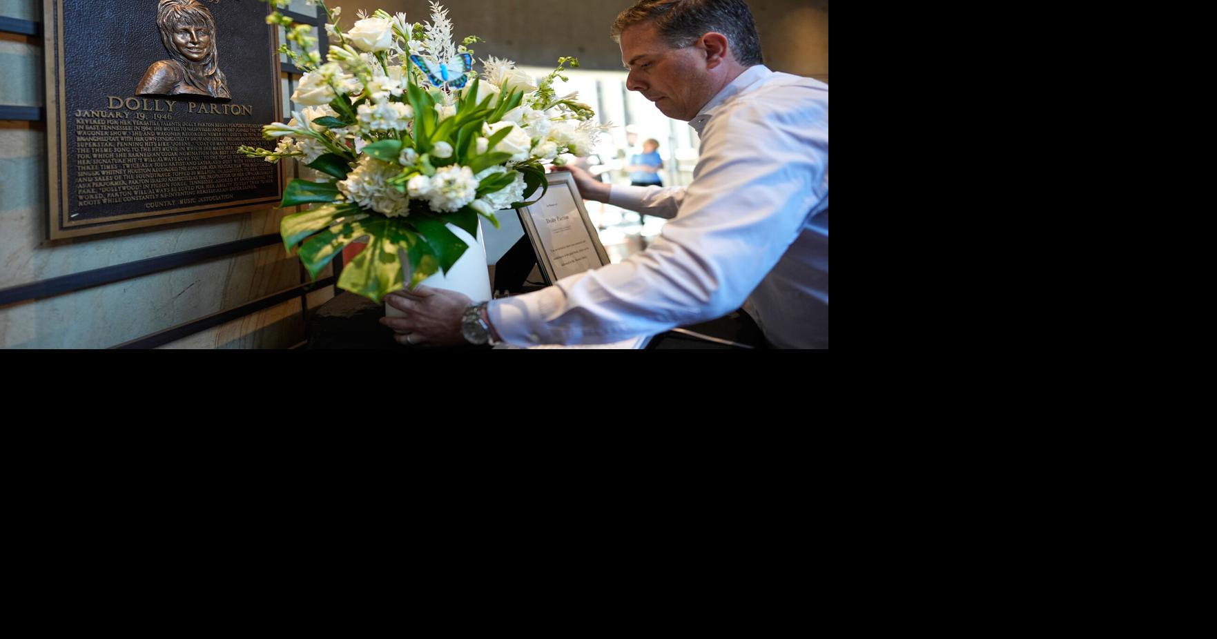 Ben Hall places flowers near Dolly Parton's plaque
