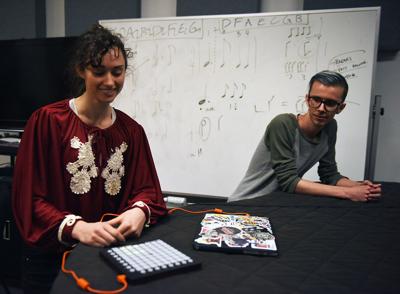 Libby Roberts, left, and Mikkel Christensen, right, explain a performance they co-composed