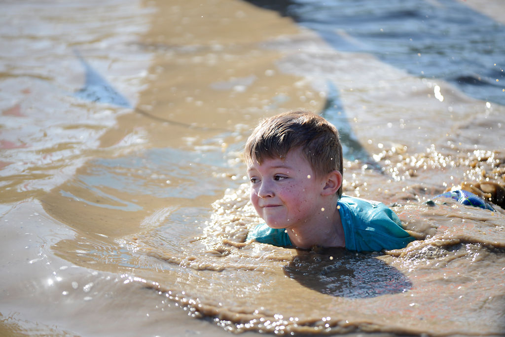 Nearly 1,000 kids get dirty at annual mud run | Local ...