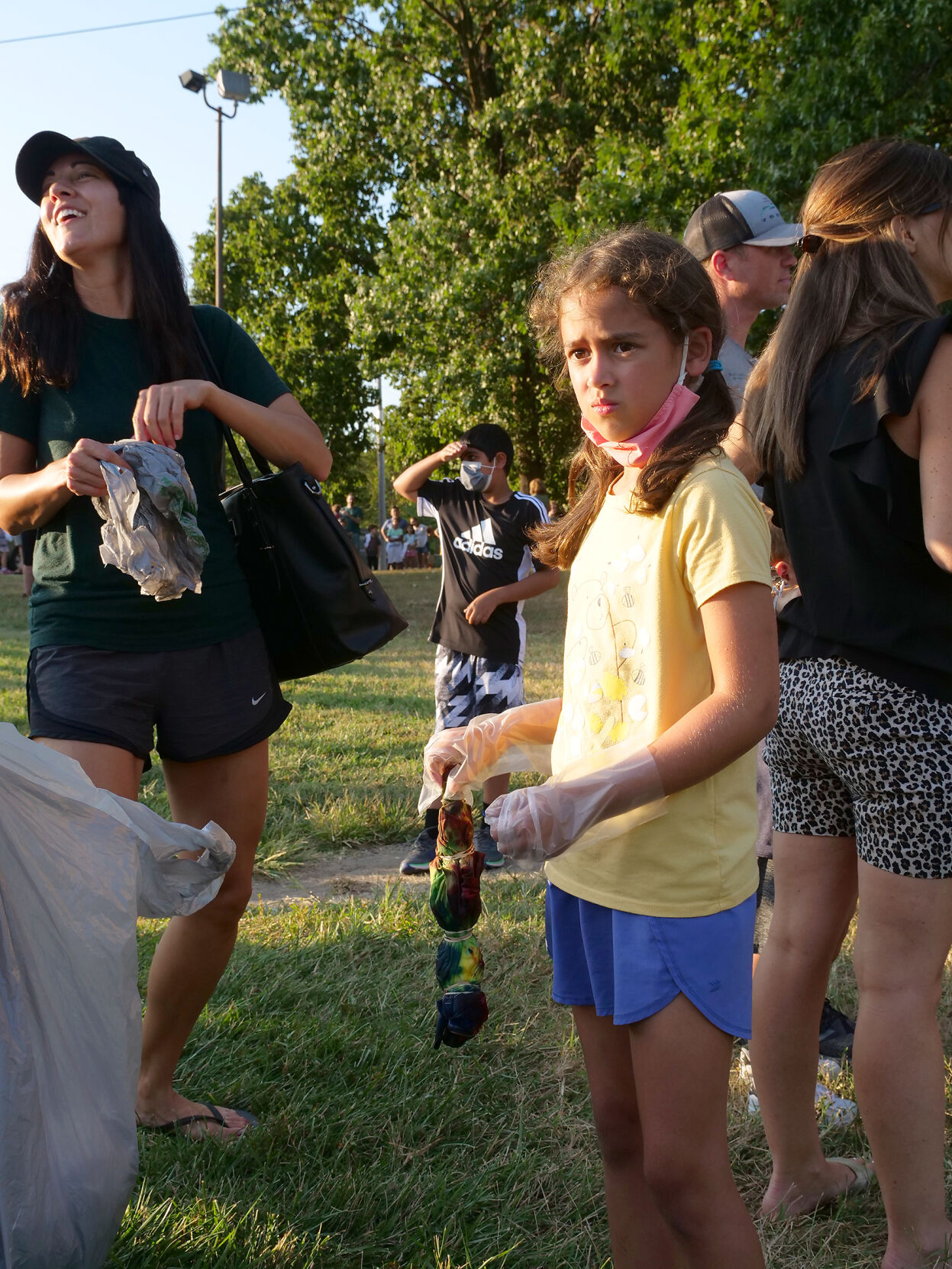 Macie Peterman laughs as Melody Mixon holds her tie-dye shirt