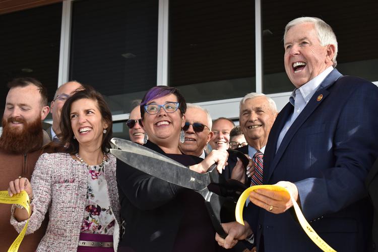 From left, Jefferson City Mayor Carrie Tergin, Columbia Mayor Barbara Buffalo, and Gov. Mike Parson cut the ribbon, signaling the opening of the new terminal at the airport