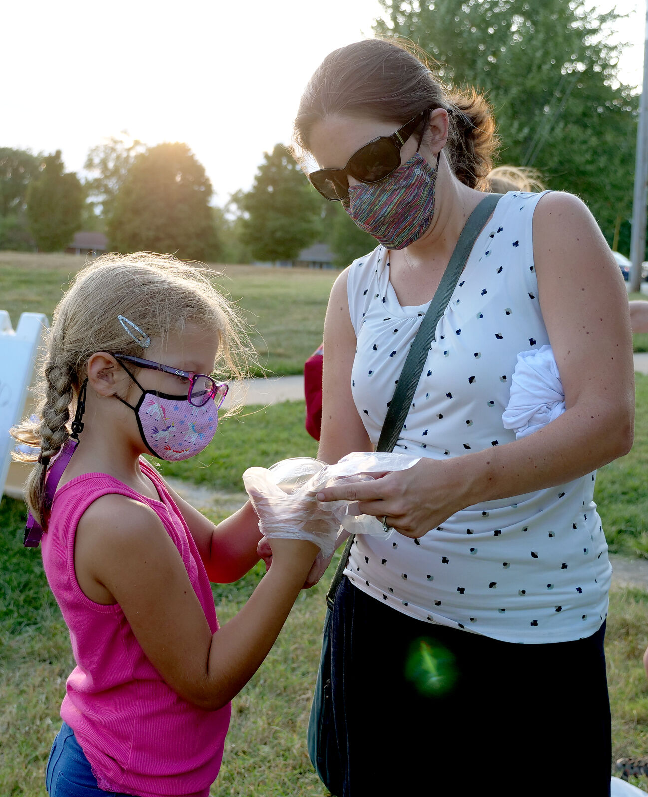 Herra and Sonja Stanis put on latex gloves to tie dye t-shirts