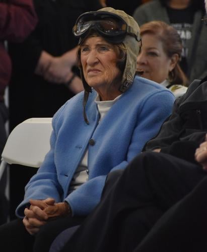 Judy Elliott observes the ceremony wearing her grandfather’s flight goggles