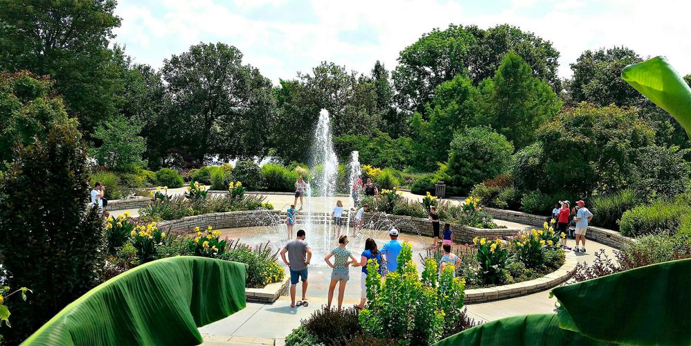 Visitors observe the fountain at the Fountain Garden.