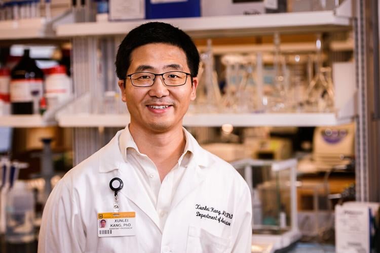 Xunlei Kang, MD, PhD, in his laboratory