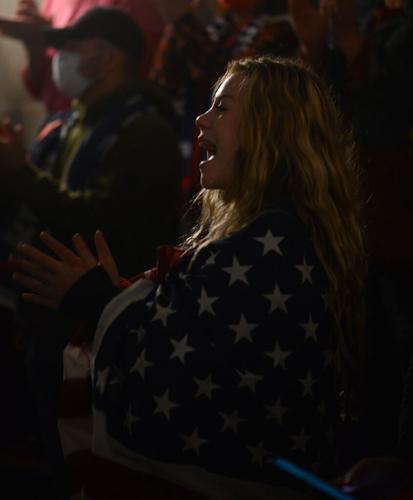 A Trump supporter claps her hands and shouts "four more years" inside the rotunda at the Missouri State Capitol