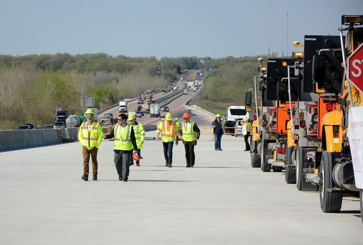 A group of presentation attendees walk up the new Rocheport Bridge ramp