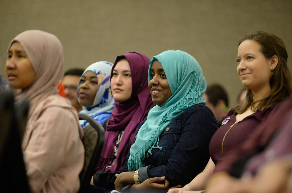 Crowd members listen to Suhaib Webb speak about Islamaphobia