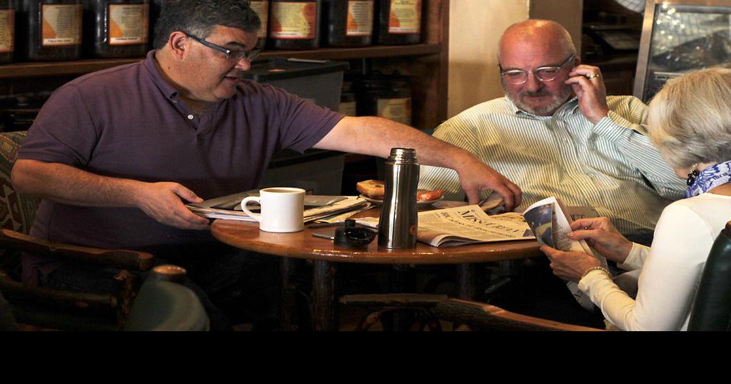 Greg Grupe, left, chats with Jim Levin, center, and Cricket Dunn
