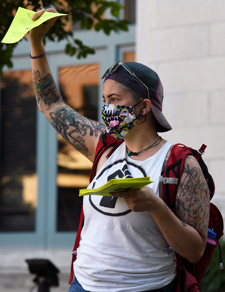 An organizer passes out flyers as protesters are gathered at the Boone County Courthouse on Sunday