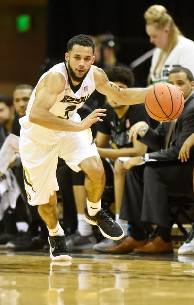 Kassius Robertson drives the ball down the court