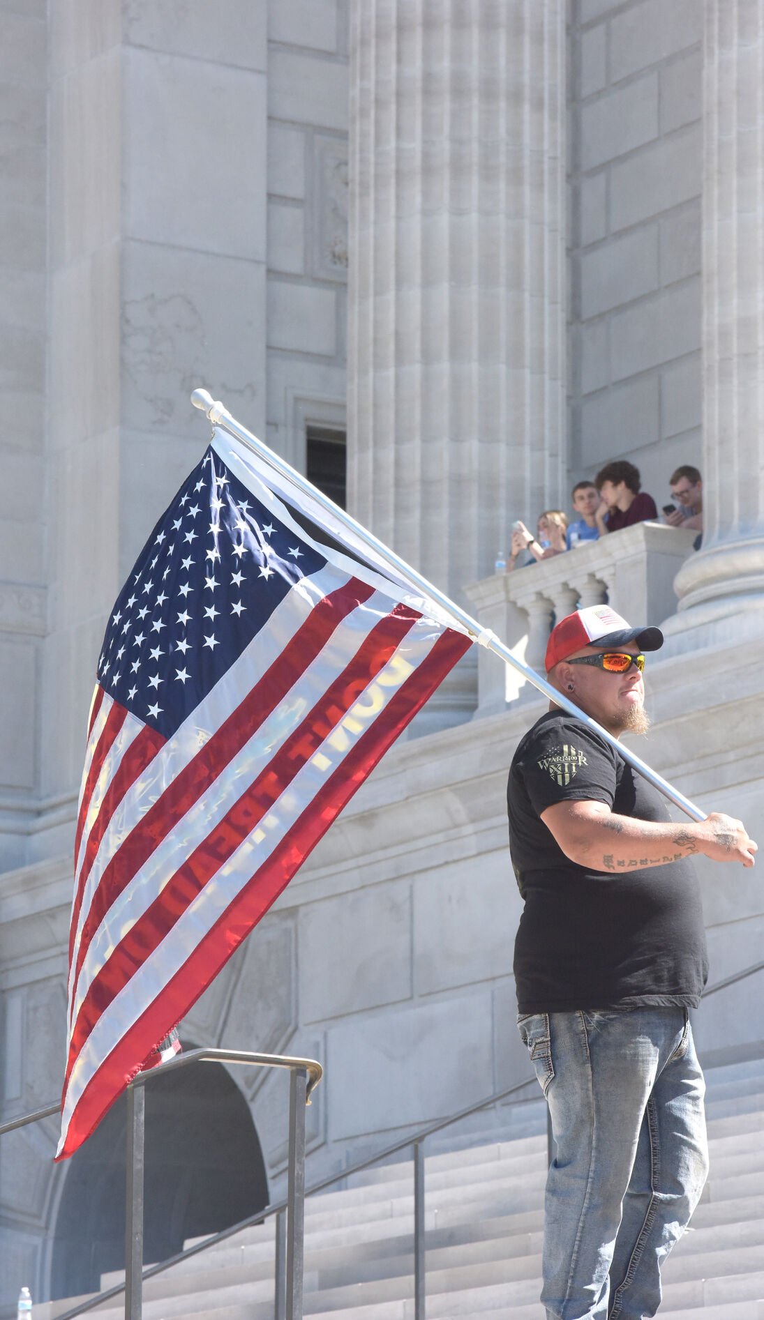 A protestor holds an American flag