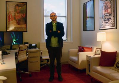 Robert Greene stands in his office