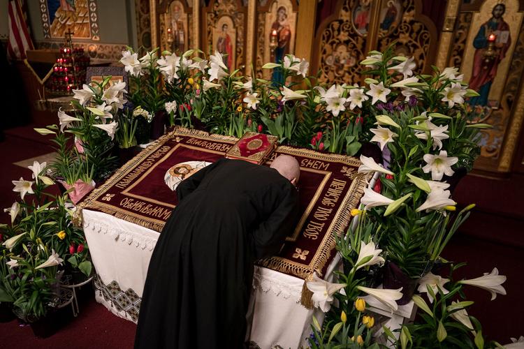 Mike Jones kisses an image of Christ during a Good Friday service at St. Mary's Ukrainian Orthodox Cathedral