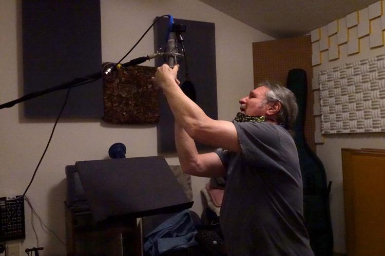 Pete Szkolka fixes a microphone