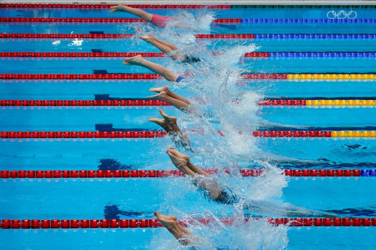 Swimmers enter the water