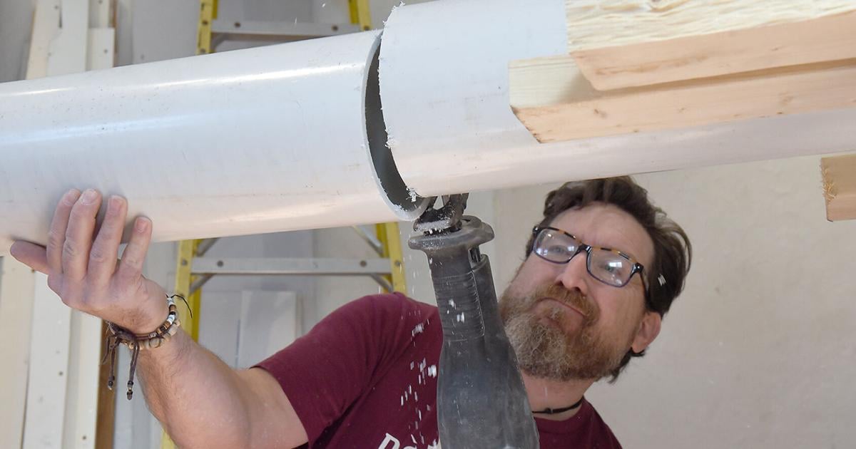 Brett Dufur saws PVC pipe to create the time capsule shell | News ...