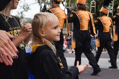 Claire Fail, 6, claps for Marching Mizzou during the homecoming parade