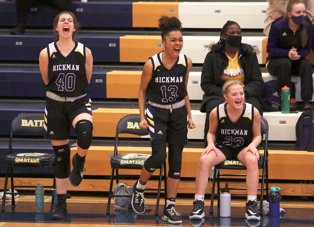Hickman basketball players cheer on their team