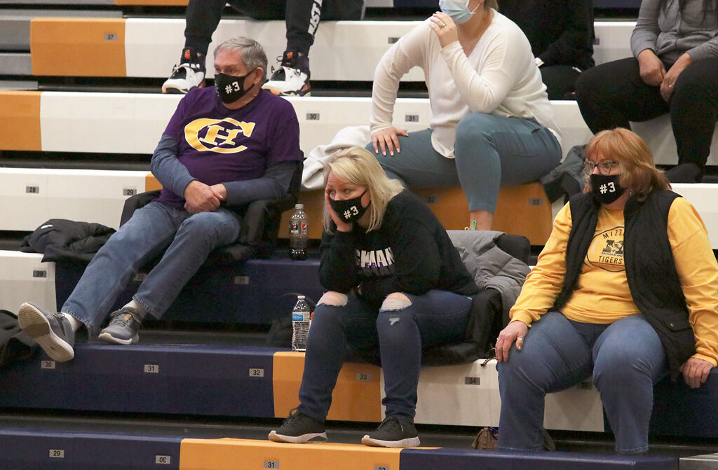 Kacy Howell sits with her parents