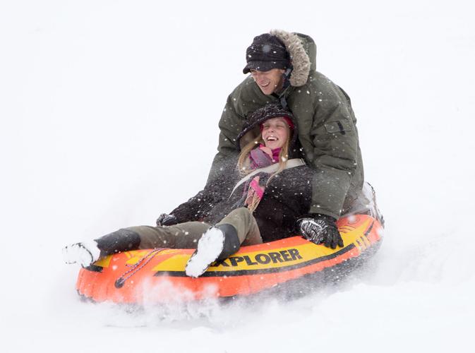 Columbia, MO families sled in fresh snow from winter storm