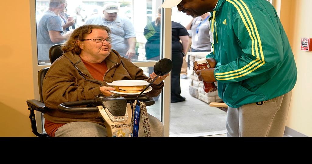 Clayborn Jones helps Virginia Piltz Photos